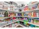 Organized walk-in pantry featuring multiple shelves and ample storage space at 1933 Griffin Dr, Brighton, CO 80601