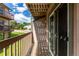 Charming balcony with wood floors, glass sliding doors, and railing with neighborhood views at 902 S Yukon St, Lakewood, CO 80226