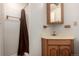 Well-lit bathroom features a brown shower curtain and a wood-trimmed vanity at 902 S Yukon St, Lakewood, CO 80226
