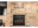 Traditional fireplace with black doors and a modern art piece above at 902 S Yukon St, Lakewood, CO 80226