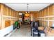 Unfinished garage with storage shelves, overhead lighting, and ample space for storage at 902 S Yukon St, Lakewood, CO 80226