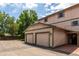 Attached two-car garage with green trim and plenty of driveway parking at 902 S Yukon St, Lakewood, CO 80226