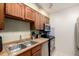 Well-equipped kitchen featuring wood cabinets, stainless steel appliances and tiled backsplash at 902 S Yukon St, Lakewood, CO 80226