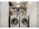 Functional laundry room features a Samsung washer and dryer and ample storage on wire shelving at 902 S Yukon St, Lakewood, CO 80226