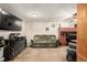 Cozy living room with neutral carpet, ceiling fan, and olive green sofa at 902 S Yukon St, Lakewood, CO 80226