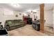 Comfortable living room features neutral carpet, sofa, chair, and wooden columns at 902 S Yukon St, Lakewood, CO 80226
