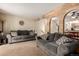 Spacious living room featuring brick accents, archways, and two comfortable sofas at 902 S Yukon St, Lakewood, CO 80226