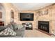 Cozy living room features a fireplace, television and comfortable grey sofa at 902 S Yukon St, Lakewood, CO 80226