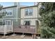 Townhouse with a private deck with a patio umbrella surrounded by mature trees at 912 S Paris Ct, Aurora, CO 80012