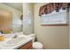 Functional half bathroom featuring modern fixtures and window with valance for added privacy at 912 S Paris Ct, Aurora, CO 80012