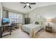 Bright bedroom featuring a ceiling fan, natural light, and desk area for a comfortable and functional space at 912 S Paris Ct, Aurora, CO 80012