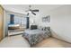 Inviting bedroom features a ceiling fan, bright natural light, and carpeted floors at 912 S Paris Ct, Aurora, CO 80012