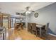 Open dining area featuring hardwood floors, modern lighting and seamlessly connected to kitchen at 912 S Paris Ct, Aurora, CO 80012
