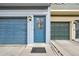Close-up of a front door and garage with address number, stylish glass, and adjacent parking at 912 S Paris Ct, Aurora, CO 80012