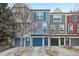 Charming townhomes with colorful facades, attached garages, and well-maintained landscaping on a sunny day at 912 S Paris Ct, Aurora, CO 80012