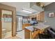 Well-lit kitchen featuring stainless steel appliances, warm wood cabinetry and bar stool seating at 912 S Paris Ct, Aurora, CO 80012