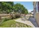 Grassy backyard with patio and table and chairs, surrounded by a wood fence at 7371 S Mobile St, Aurora, CO 80016