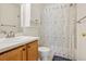 Well-lit bathroom featuring a vanity sink with a floral shower curtain at 7371 S Mobile St, Aurora, CO 80016