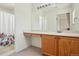 Bathroom features a white countertop vanity and tub with floral shower curtain at 7371 S Mobile St, Aurora, CO 80016