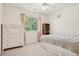 Cozy bedroom with neutral decor features a ceiling fan and bright window at 7371 S Mobile St, Aurora, CO 80016