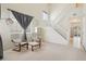Inviting living room with a high ceiling, neutral carpet, bright natural light, and staircase access at 7371 S Mobile St, Aurora, CO 80016