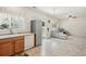 Open-concept kitchen and living area, with stainless steel refrigerator and patio door access at 7371 S Mobile St, Aurora, CO 80016