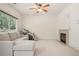 Spacious living room with a cozy fireplace, neutral color scheme, and lots of natural light at 7371 S Mobile St, Aurora, CO 80016