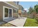 Back patio with table and four chairs overlooking the grassy backyard at 7371 S Mobile St, Aurora, CO 80016