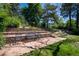 Landscaped backyard featuring a brick patio and terraced garden beds at 2744 S Newton Way, Denver, CO 80236