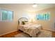 Cozy bedroom with hardwood floors, neutral paint, and plenty of natural light at 2744 S Newton Way, Denver, CO 80236