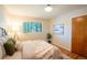 Comfortable bedroom featuring hardwood floors, a bright window, and neutral décor at 2744 S Newton Way, Denver, CO 80236