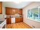 Bright kitchen with wood cabinets, a tiled backsplash, granite countertops, and lots of natural light at 2744 S Newton Way, Denver, CO 80236