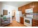 Efficient kitchen featuring wood cabinets, granite countertops, and modern appliances at 2744 S Newton Way, Denver, CO 80236