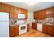 Spacious kitchen featuring wood cabinetry, granite countertops, and updated appliances at 2744 S Newton Way, Denver, CO 80236
