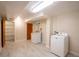 Spacious laundry room with tile flooring, shelving, and modern appliances at 2744 S Newton Way, Denver, CO 80236