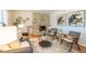 Inviting living room featuring a stone fireplace, stylish seating, and modern decor at 2744 S Newton Way, Denver, CO 80236