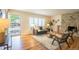 Cozy living room with a decorative stone fireplace, hardwood floors, and bright natural light at 2744 S Newton Way, Denver, CO 80236