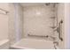 Bathtub with marble tiling and a shower head with a chrome finish at 6470 S Dayton St # K12, Englewood, CO 80111