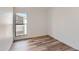 Bedroom with wood-look floors and a large window for natural light at 6470 S Dayton St # K12, Englewood, CO 80111