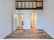 Bright bedroom with hardwood floors, white walls and access to two additional rooms at 6470 S Dayton St # K12, Englewood, CO 80111