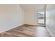 Well-lit bedroom with a vaulted ceiling, hardwood floors and a large picture window at 6470 S Dayton St # K12, Englewood, CO 80111