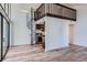 Lofted living room with wood floors, a spiral staircase and a view into the kitchen at 6470 S Dayton St # K12, Englewood, CO 80111