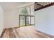 Sun-filled living room featuring hardwood floors and a large sliding glass door to the outside patio at 6470 S Dayton St # K12, Englewood, CO 80111