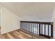 Angled view of the loft featuring wood-look flooring and a safety gate at 6470 S Dayton St # K12, Englewood, CO 80111