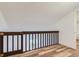 Interior view of the loft featuring wood-look flooring and a safety gate at 6470 S Dayton St # K12, Englewood, CO 80111