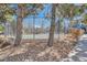 Community tennis court surrounded by trees and stone landscaping for outdoor recreation at 6470 S Dayton St # K12, Englewood, CO 80111