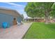 Backyard featuring a patio with outdoor seating, storage shed, lush green grass, mature trees and home at 4320 Teller St, Wheat Ridge, CO 80033