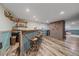 Finished basement features a bar area and brick accent wall at 4320 Teller St, Wheat Ridge, CO 80033