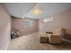 Finished basement featuring neutral carpet, light fixture, and comfortable seating area with recliner and ottoman at 4320 Teller St, Wheat Ridge, CO 80033