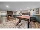 Basement bedroom featuring brick fireplace and wood style flooring at 4320 Teller St, Wheat Ridge, CO 80033